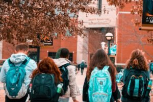 Students with backpacks are on their way to school