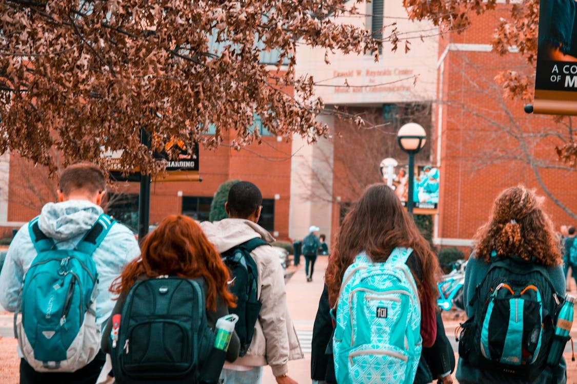 Students with backpacks are on their way to school
