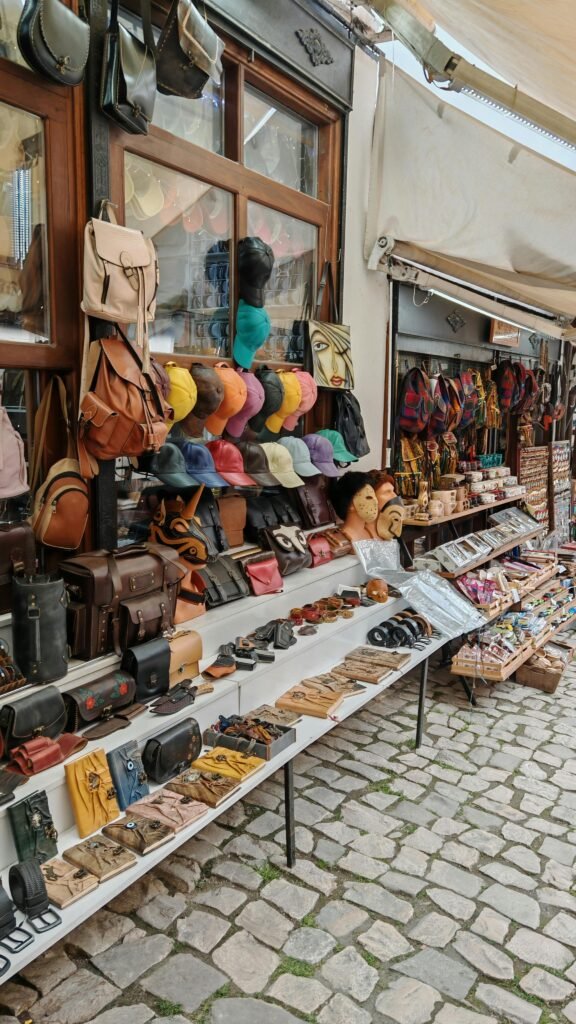Market stall with various bags, hats, and accessories