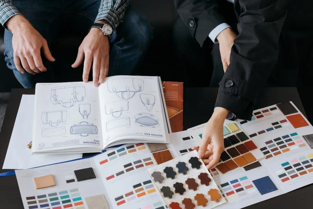 Hands explore bag designs, materials, and color samples, shaping the perfect creation