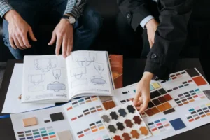 Hands explore bag designs, materials, and color samples, shaping the perfect creation