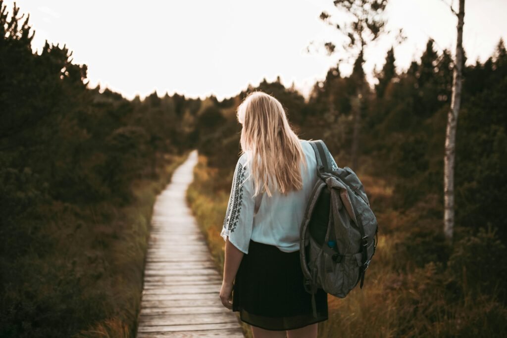 Woman backpacking: woodland trail, serene escape