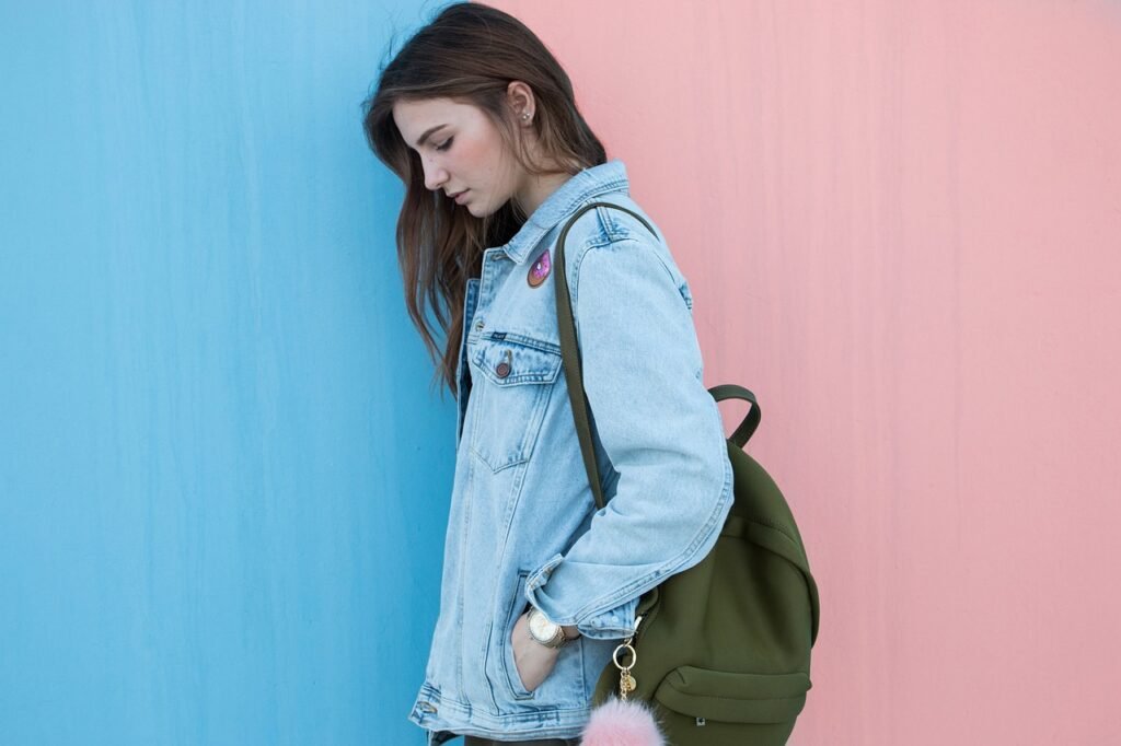 woman with a backpack in pink and blue background